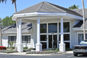Technician installing aluminum gutters on a Sarasota commercial building